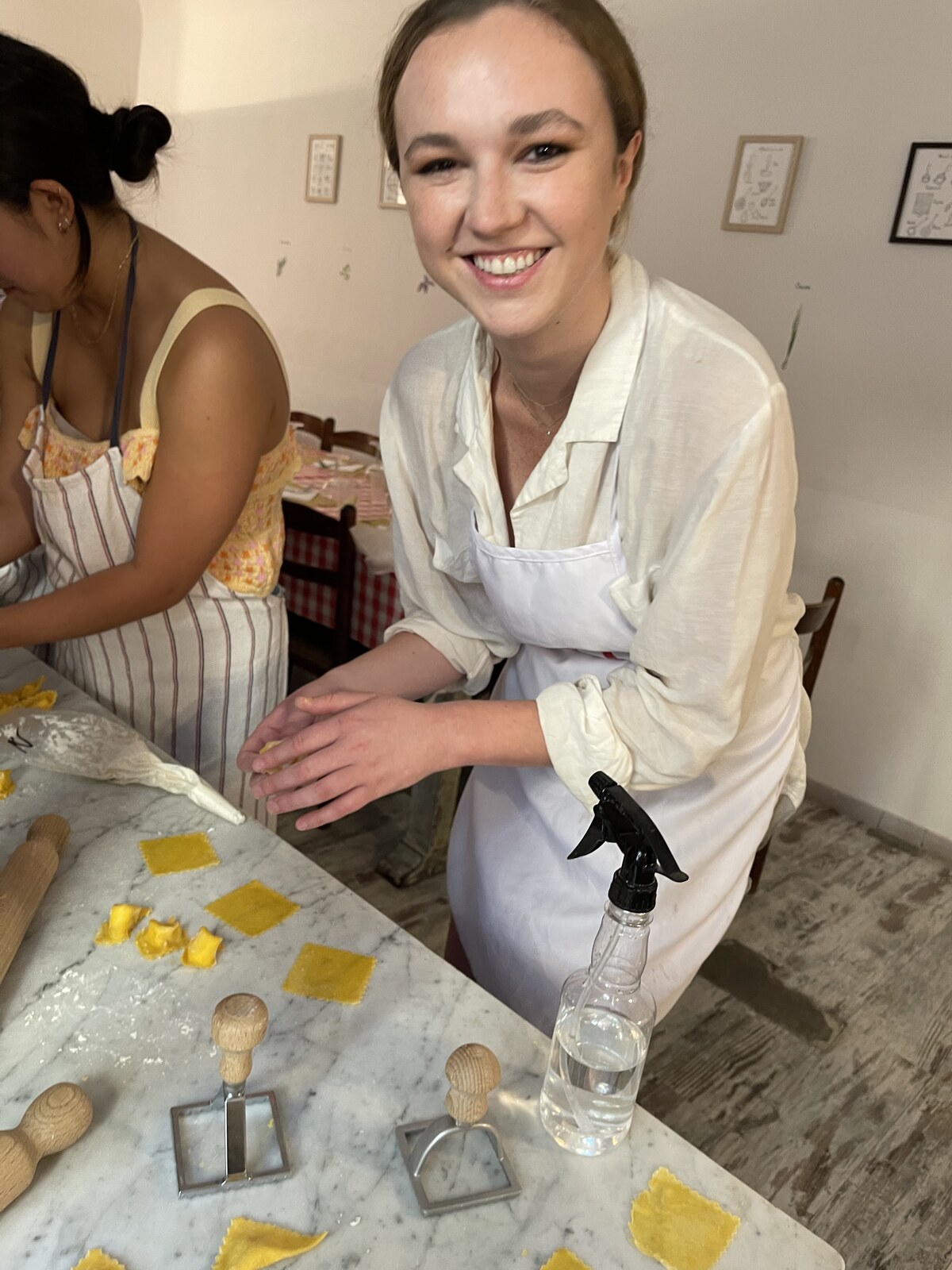 Maunder's founder rolling fresh ravioli on a marble counter in a small Italian cooking class
